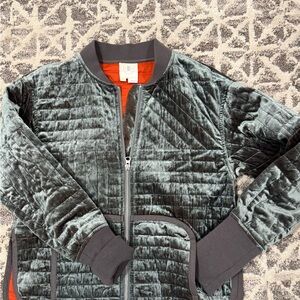 Velvet Quilted Jacket in mossy green and vibrant orange quilted lining